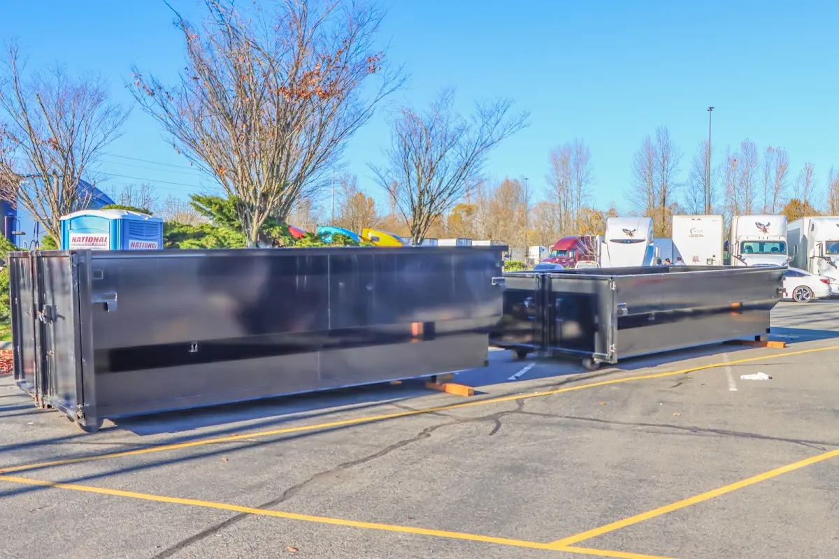 Professional dumpster rental service with roll-off container on residential driveway in Bryn Mawr-Skyway